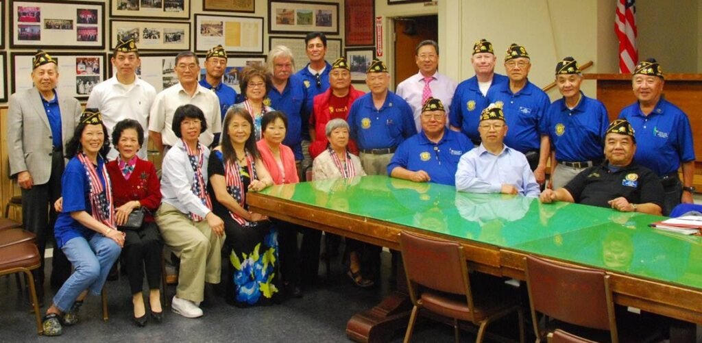 Post 628 veterans, families, and friends gathered around a meeting table.